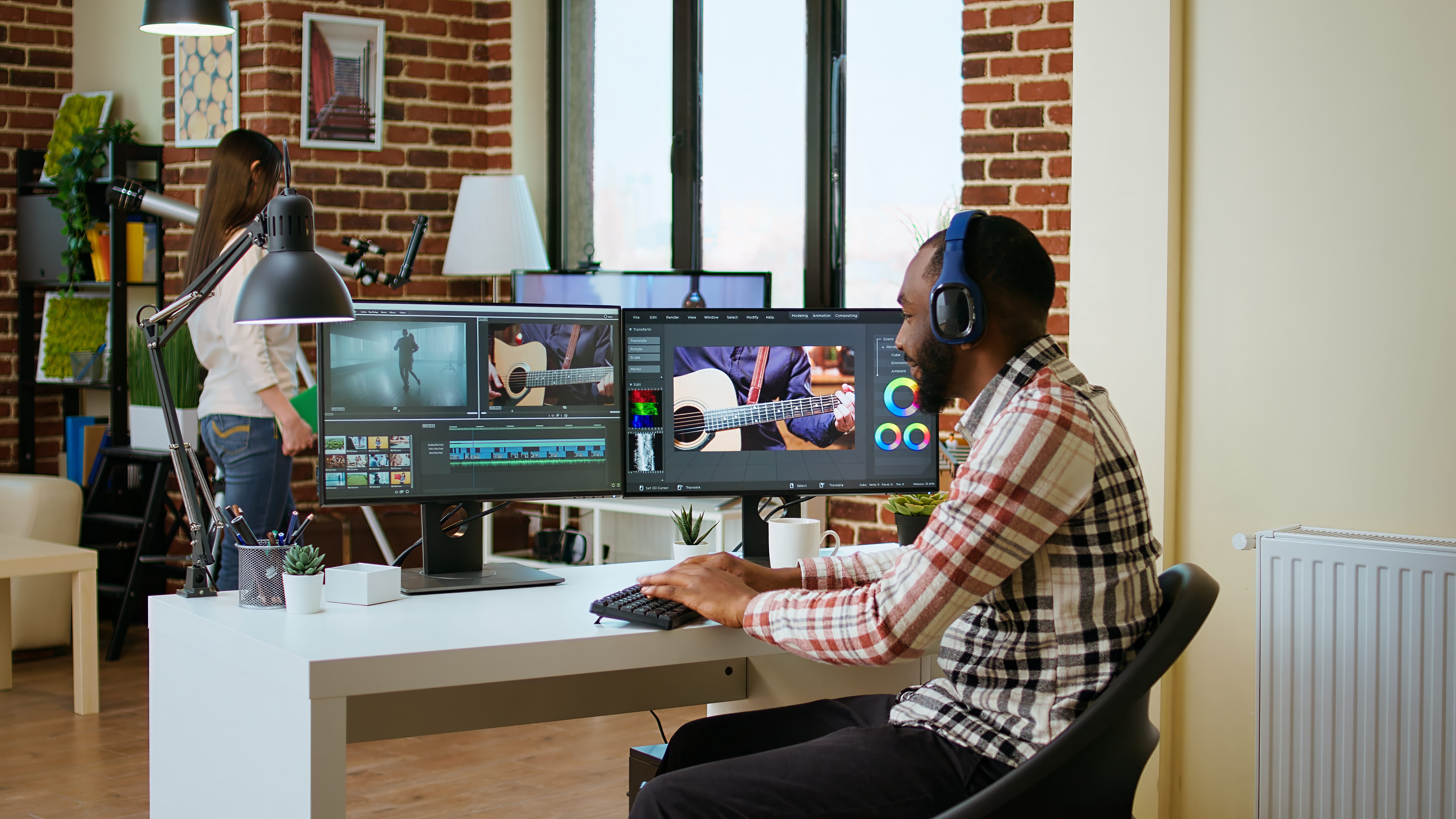 Video editor working at a dual-monitor editing workstation